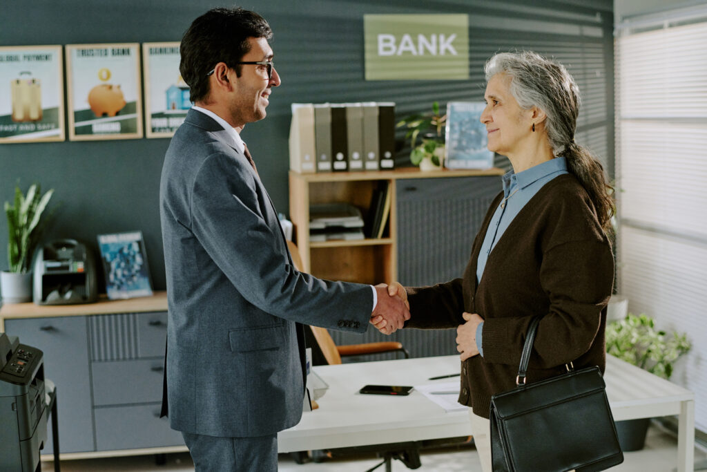 businessman shaking hands with elderly hispanic wo 2025 04 06 06 20 26 utc